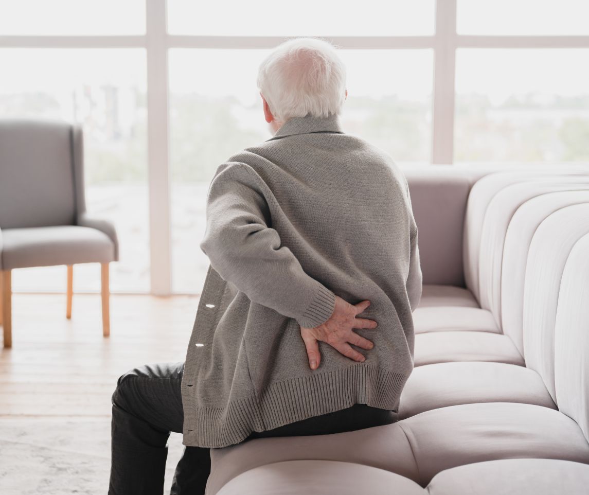 Senior old elderly man grandfather touching his back, suffering from backpain, sciatica, sedentary lifestyle concept. Spine health problems. Healthcare, insurance