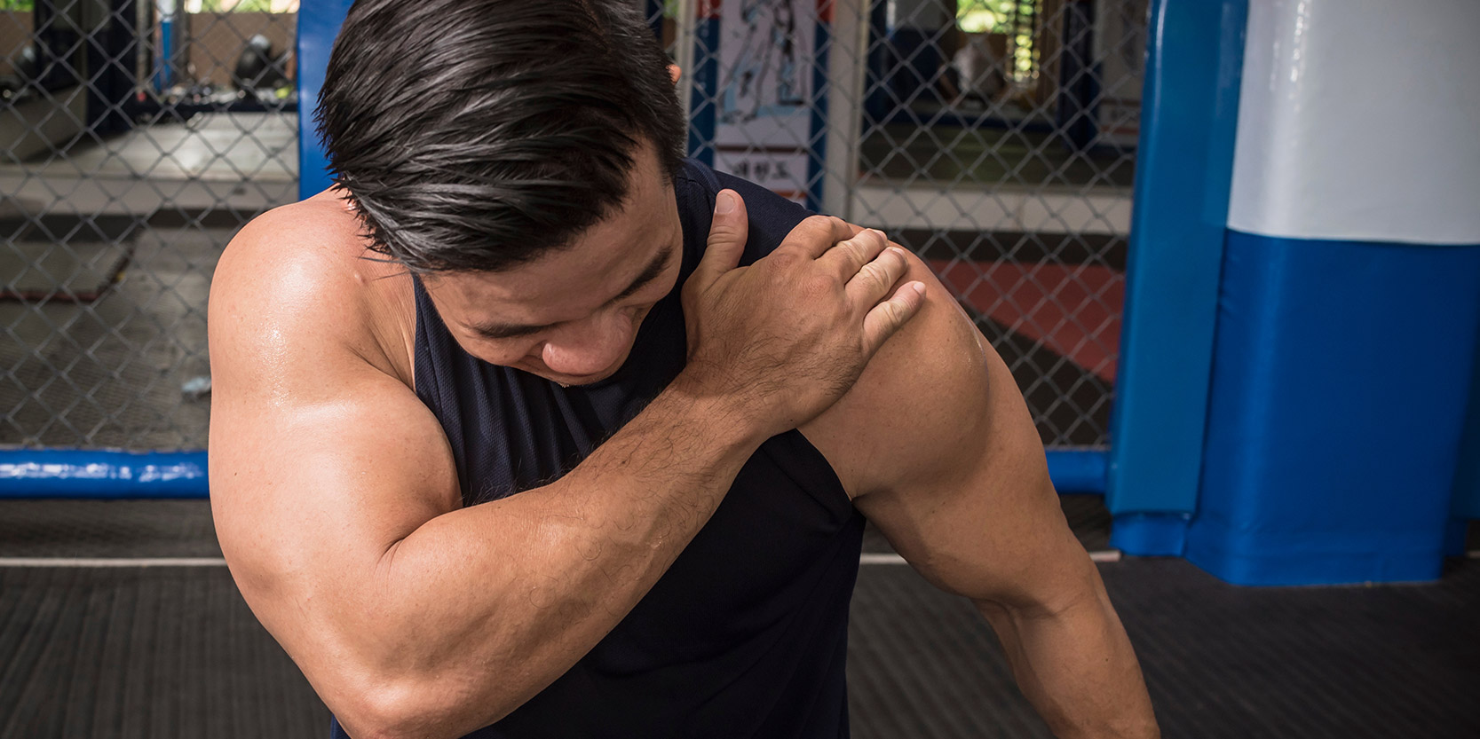 athlete holding his shoulder in pain