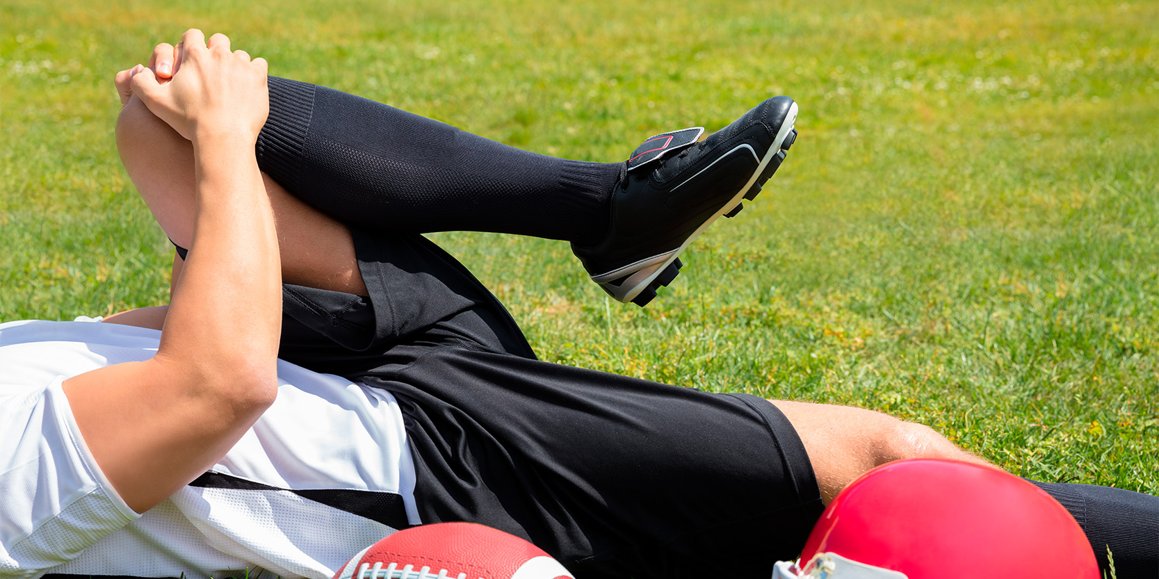 a football player stretching his leg