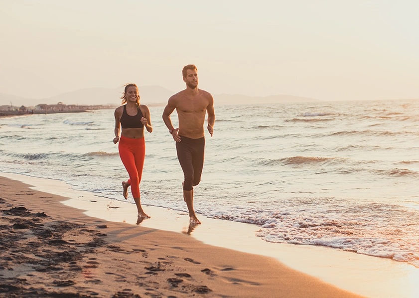 couple running at the beach
