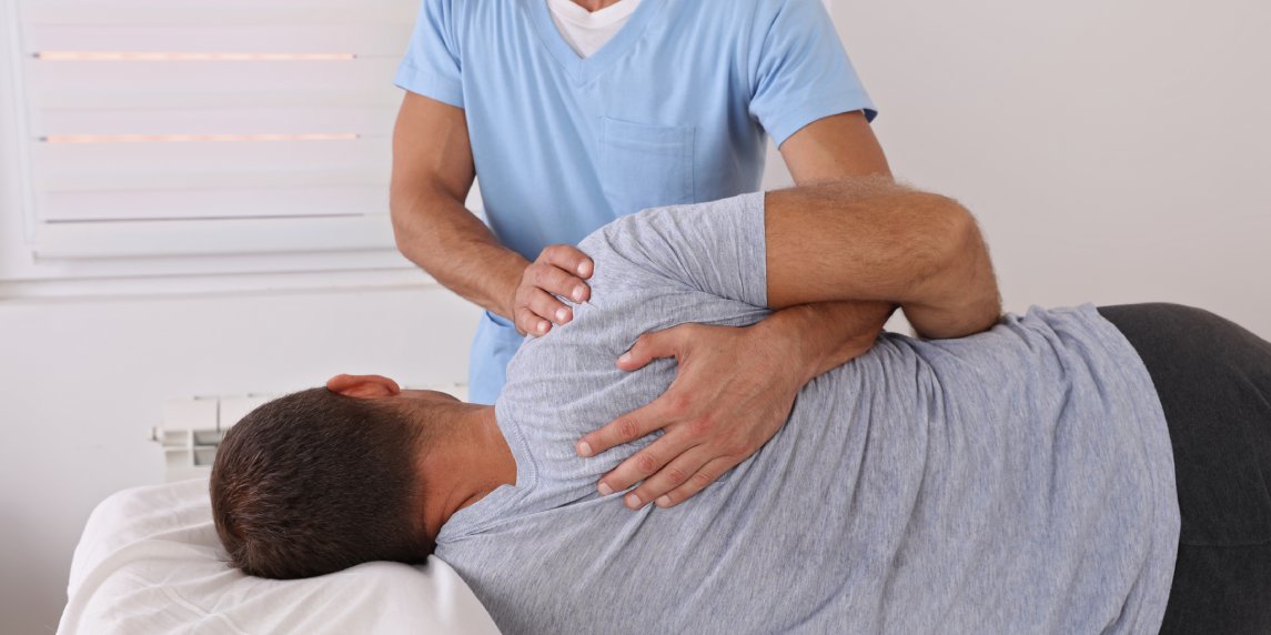 Back pain , Physiotherapy. Man Chiropractic pain relief adjustment /Kinesiology treatment . Osteopathy practitioner