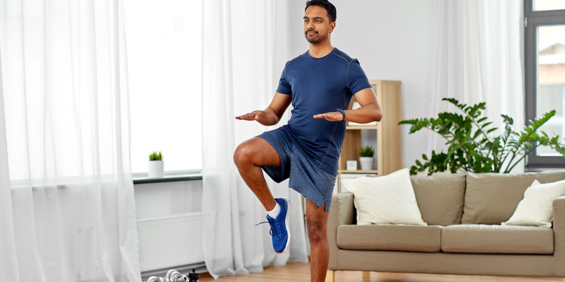 sport, fitness and healthy lifestyle concept - indian man running on spot at home