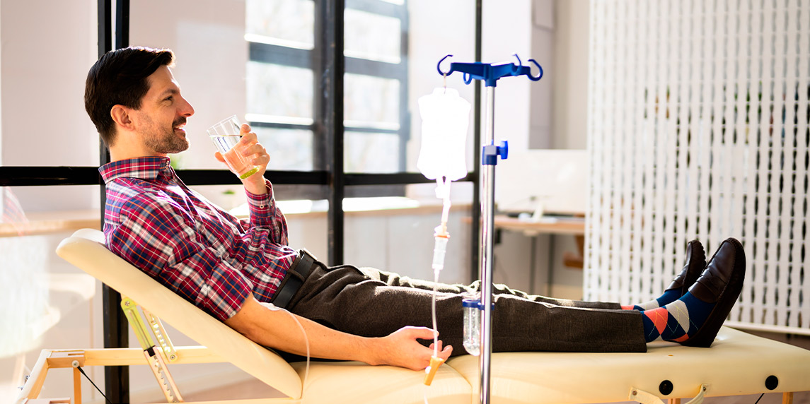 A man in a chair undergoing IV therapy, emphasizing its role in immune support for professionals.
