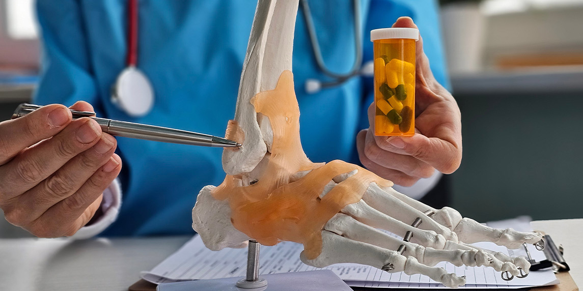 A physician displays a foot model, emphasizing important considerations for selecting a chiropractor.